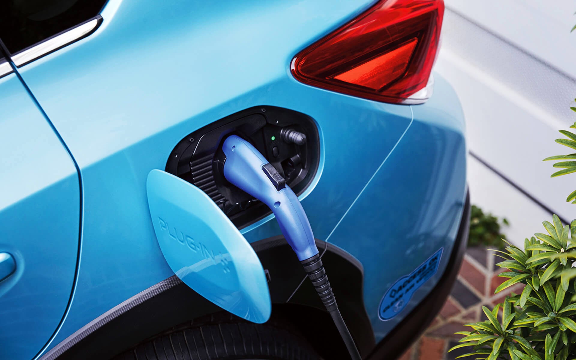 A close-up of the Subaru Crosstrek Hybrid's charging port with charging cable plugged in | Sierra Subaru of Monrovia in Monrovia CA