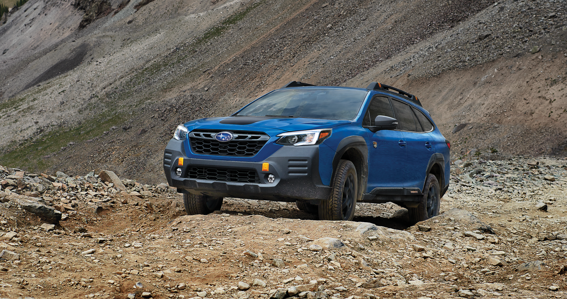 A 2023 Outback Wilderness driving on a trail in the mountains. | Sierra Subaru of Monrovia in Monrovia CA